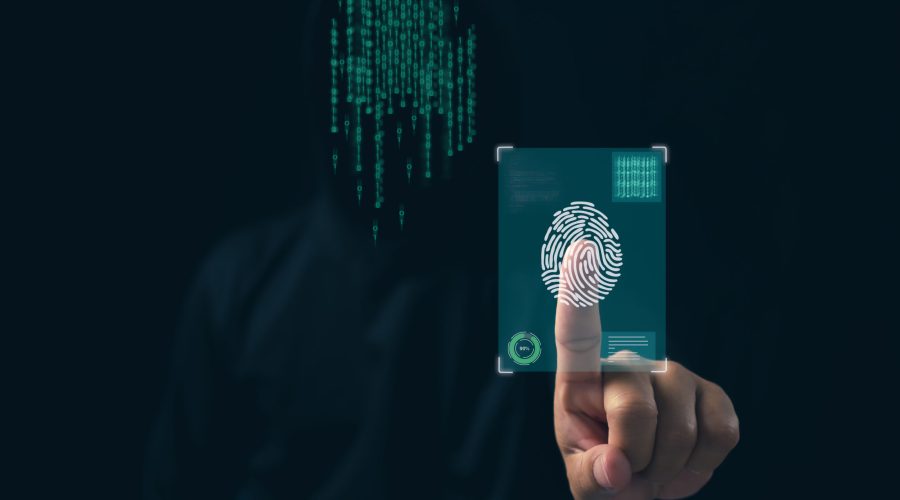 Hacker is scanning fingerprints in the dark. Concept of information security in internet networks and espionage.